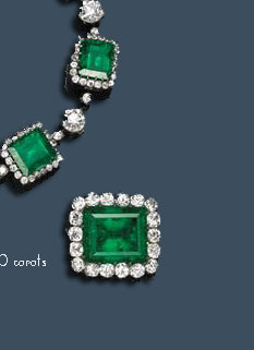 A French art deco emerald, diamond and platinum brooch, Cartier 
the brooch centering a sugarloaf-shaped emerald cabochon measuring approximately 22.08 x 21.04 x 14.95mm, flanked by two old pear-shaped diamonds set in horizontal fashion, weighing 7.69 and 7.08 carats. Signed Cartier, Paris.Source: Bonham
